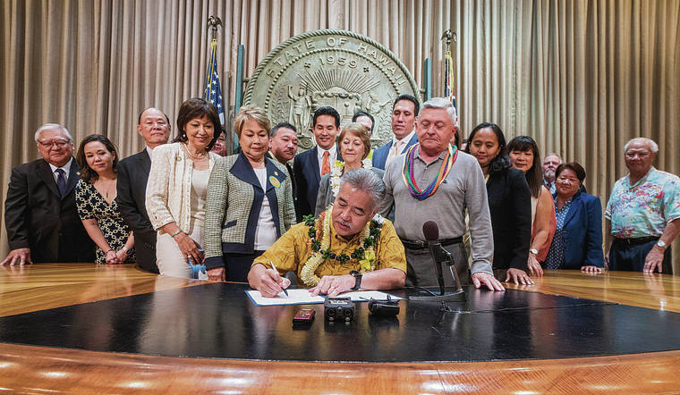 STAR-ADVERTISER
                                John Radcliffe’s right-to-die lawsuit led to House Bill 2739 “Our Care, Our Choice Act.” Gov. David Ige signed the bill into law on April 5, 2018, making Hawaii the seventh jurisdiction to codify an end-of-life choice. The law was modeled after Oregon’s Death with Dignity Act and allows qualified terminally ill adults who are mentally competent to legally obtain prescription medication to end their life in a humane and dignified manner. Radcliffe, who was diagnosed with cancer at the time, is standing to the right of Ige.
