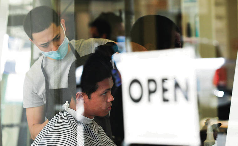 JAMM AQUINO / JAQUINO@STARADVERTISER.COM
                                Under Oahu’s new stay-at-home order, salons and barbershops will be forced to close for two weeks. A man had his hair cut Tuesday at the Hawaii Institute for Hair Design in Honolulu.