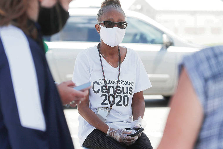 ASSOCIATED PRESS
                                Amid concerns of COVID-19 spread, Census 2020 worker Jennifer Pope wore a mask and sat by, ready to help at a U.S. Census walk-up counting site set up last month for Hunt County in Greenville, Texas.