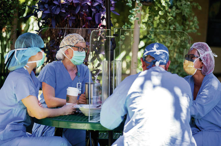 CINDY ELLEN RUSSELL / CRUSSELL@STARADVERTISER.COM
                                Hawaii is calling for more nurses to help at hospitals due to the increase in hospitalizations prompted by the surge in COVID-19 patients. Medical staff took a break together outdoors at The Queen’s Medical Center on Friday.