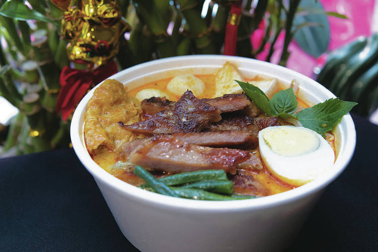 CRAIG T. KOJIMA /CKOJIMA@STARADVERTISER.COM
                                Lemongrass with pork chop laksa from SingMa Tei at Ala Moana Center.