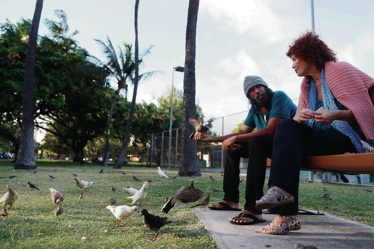 JAMM AQUINO/JAQUINO@STARADVERTISER.COM
                                Waikiki residents and Kapiolani Park regulars Tippy Ali, left, and Chiara, who did not want her last name used, fed birds as they relaxed at Kapiolani Park on Thursday.