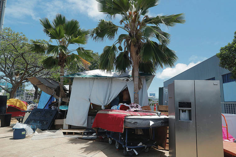 JAMM AQUINO / JAQUINO@STARADVERTISER.COM
                                A full-size refrigerator was among the appliances seen at a homeless encampment along Nimitz Highway on Monday in Honolulu.