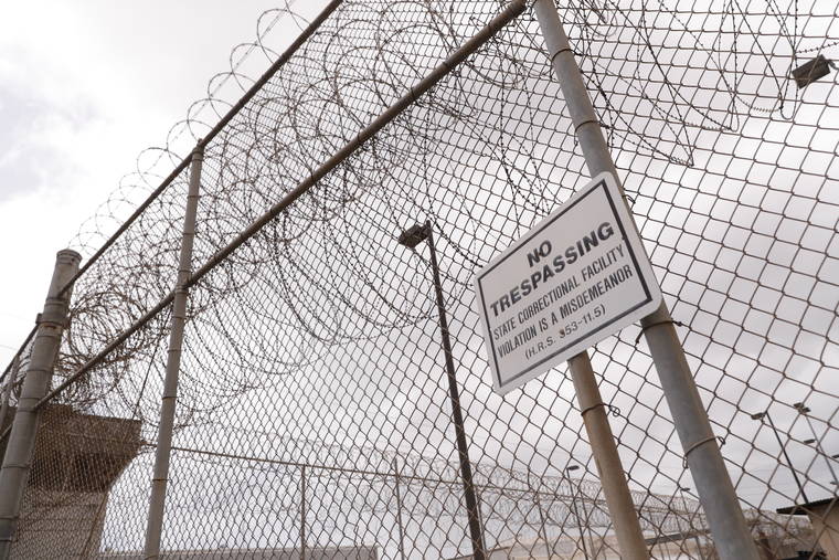 STAR-ADVERTISER / MARCH 25
                                A “No Trespassing” sign is seen on a perimeter fence at Oahu Community Correctional Center.