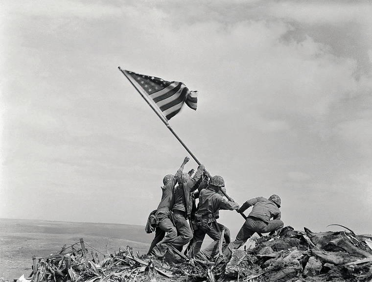 COURTESY JOE ROSENTHAL
                                American soldiers raise a flag over Mount Suribachi on Iwo Jima in one of the most famous photos of World War II.