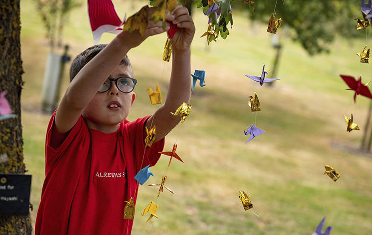 PA VIA AP
                                Nine-year-old William Saunders hung origami peace cranes in the National Memorial Arboretum in Alrewas, England.