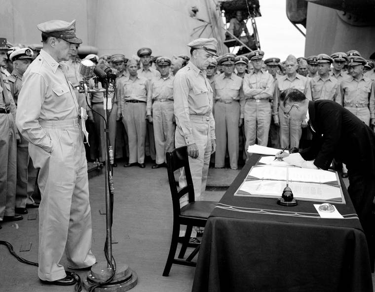 ASSOCIATED PRESS / SEPT. 1945
                                U.S. General Douglas MacArthur, left, watched as the foreign minister Manoru Shigemitsu of Japan signed the surrender document aboard the USS Missouri on Tokyo Bay. Lt. General Richard K. Sutherland, center, witnessed the ceremony marking the end of World War II with other American and British officers in the background.