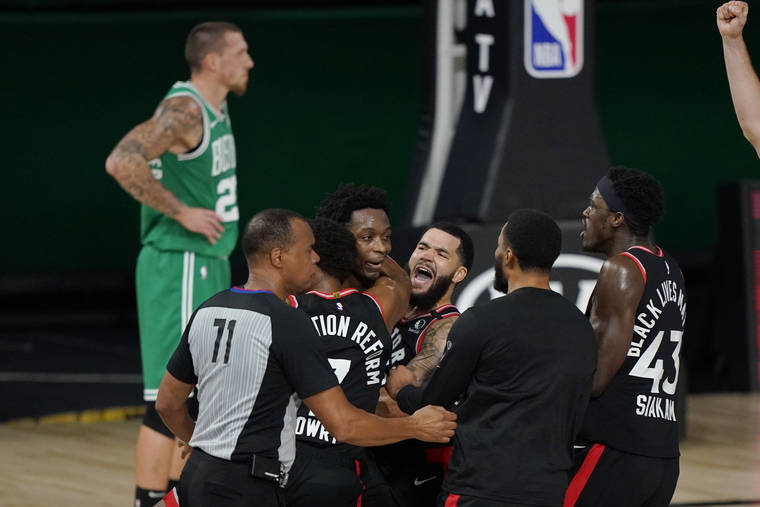 ASSOCIATED PRESS
                                Teammates mob Toronto Raptors’ OG Anunoby, second player from left, after Anunoby’s game winning shot at the buzzer in the second half of an NBA conference semifinal playoff basketball game against the Boston Celtics tonight.