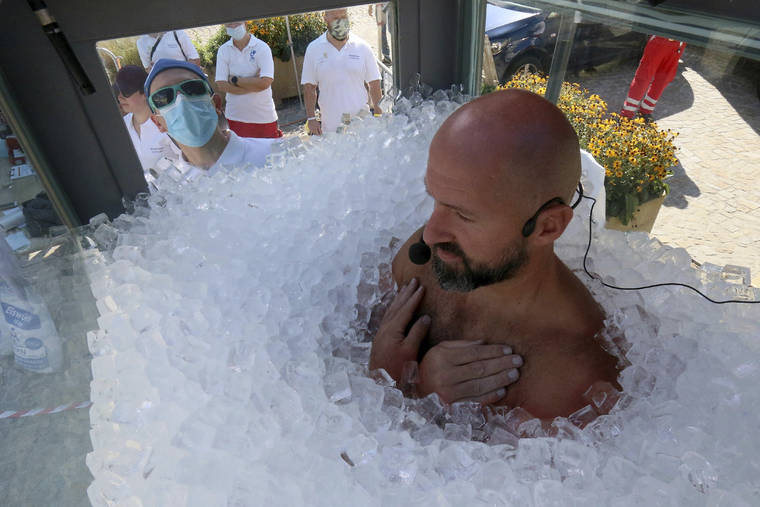 ASSOCIATED PRESS / SEPT. 5
                                Austrian ice swimmer Josef Koeberl is standing in a glass cabin filled with ice try to break the world record for a human to stay side an ice box in Melk.