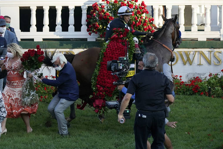 ASSOCIATED PRESS
                                Trainer Bob Baffert is knocked to ground as Jockey John Velazquez try to control Authentic in the winners’ circle after winning the 146th running of the Kentucky Derby at Churchill Downs in Louisville, Ky.
