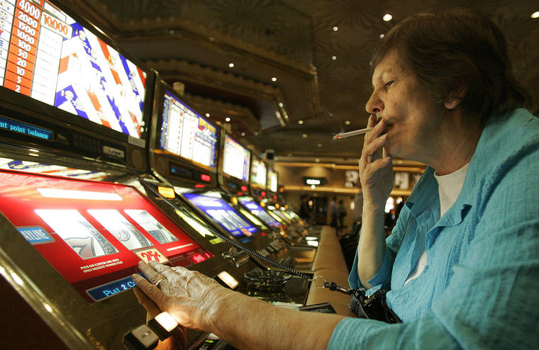 ASSOCIATED PRESS / DEC. 2005
                                Judy King of Daytona Beach, Fla., held her cigarette while playing a slot machine at the MGM Grand hotel-casino in Las Vegas. One of the last Las Vegas Strip resorts to reopen after coronavirus closures will be the first to be smoke-free, MGM Resorts International announced today.