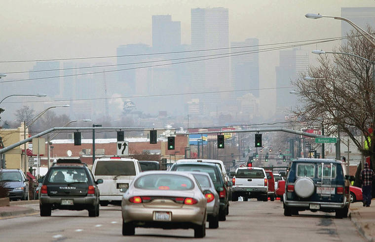 ASSOCIATED PRESS
                                Vehicles head inbound on South Broadway as polluted air obscures the view of the skyline of Denver from the south suburb of Englewood, Colo.