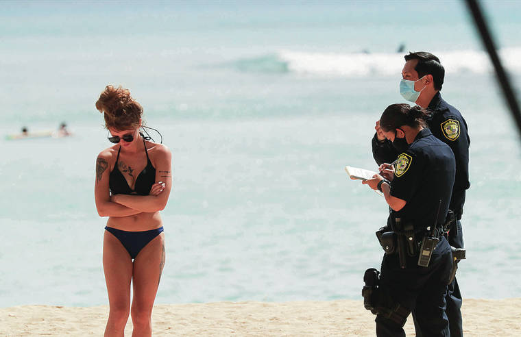 JAMM AQUINO / JAQUINO@STARADVERTISER.COM
                                Honolulu police Tuesday issued a citation to a woman in Waikiki.