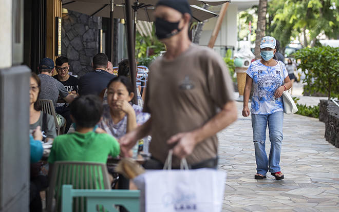 CINDY ELLEN RUSSELL / CRUSSELL@STARADVERTISER.COM
                                People dine and walk along the sidewalk at the International Market Place in Waikiki on Sunday.