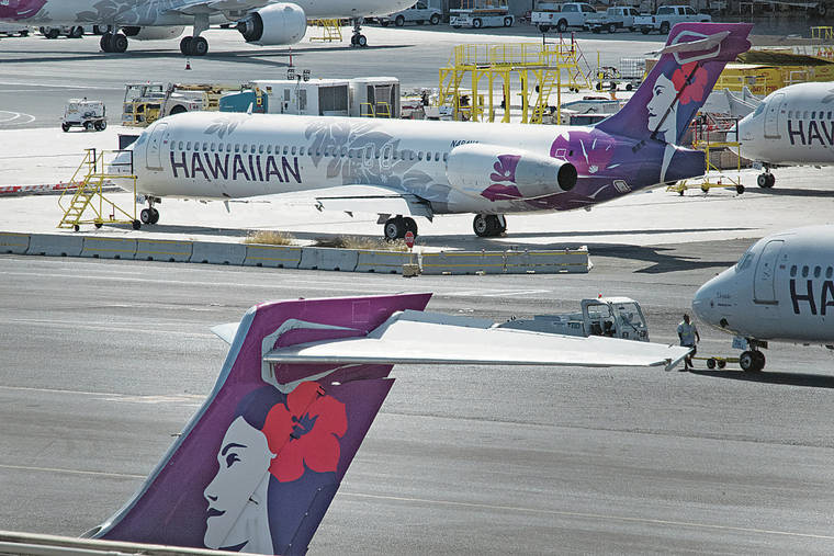 CRAIG T. KOJIMA / CKOJIMA@STARADVERTISER.COM
                                Hawaiian Air planes on the ground at Daniel K. Inouye International Airport.