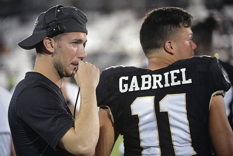 ASSOCIATED PRESS / 2019
                                Central Florida quarterback McKenzie Milton, left, stood beside fellow Mililani graduate Dillon Gabriel on the sideline during a game against Connecticut on Sept. 28, 2019, in Orlando, Fla.