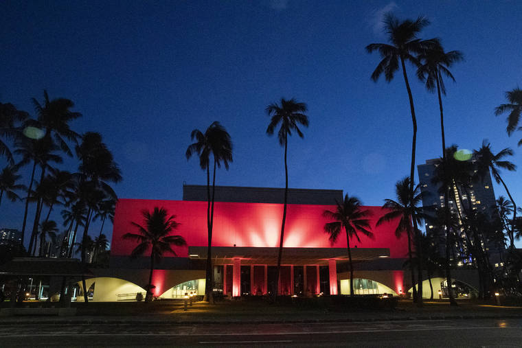 GEORGE F. LEE / GLEE@STARADVERTISER.COM
                                The Blaisdell Concert Hall was lit in red tonight.