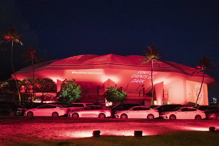 GEORGE F. LEE / GLEE@STARADVERTISER.COM
                                The Blaisdell Arena was lit in red tonight.