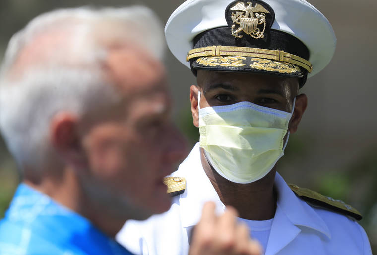 JAMM AQUINO / JAQUINO@STARADVERTISER.COM
                                Mayor Kirk Caldwell demonstrates a coronavirus swab test as U.S. Surgeon General Vice Adm. Jerome Adams, right, watches during surge COVID-19 testing on Aug. 27, at Kalakaua District Park in Honolulu. According to a criminal complaint filed in court, U.S. Surgeon General Jerome Adams was cited for being in a closed Hawaii park in August when he was here to help with the federally supported surge testing effort.