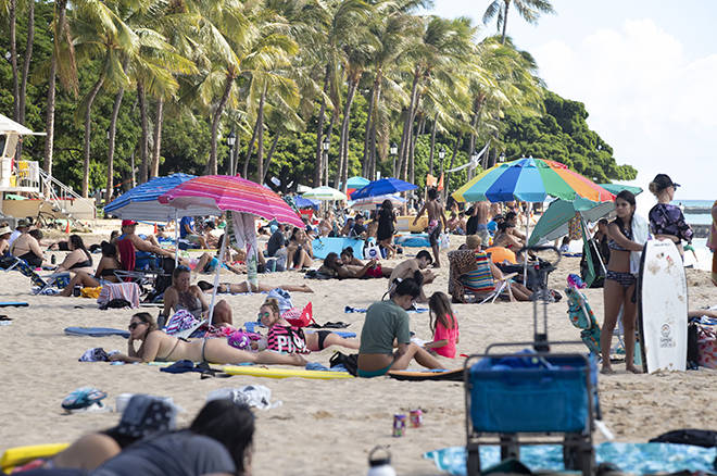 CINDY ELLEN RUSSELL / CRUSSELL@STARADVERTISER.COM
                                People hit the shores of Waikiki on Sunday after Mayor Kirk Caldwell eased some coronavirus restrictions.