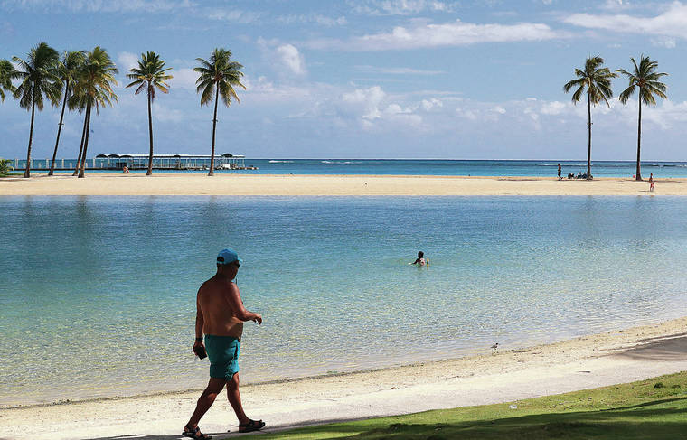 JAMM AQUINO / JAQUINO@STARADVERTISER.COM
                                Hawaii on Thursday will begin welcoming trans-Pacific travelers exempt from the state’s mandatory 14-day quarantine. A nearly empty Hilton Hawaiian Village lagoon was seen Monday in Waikiki.
