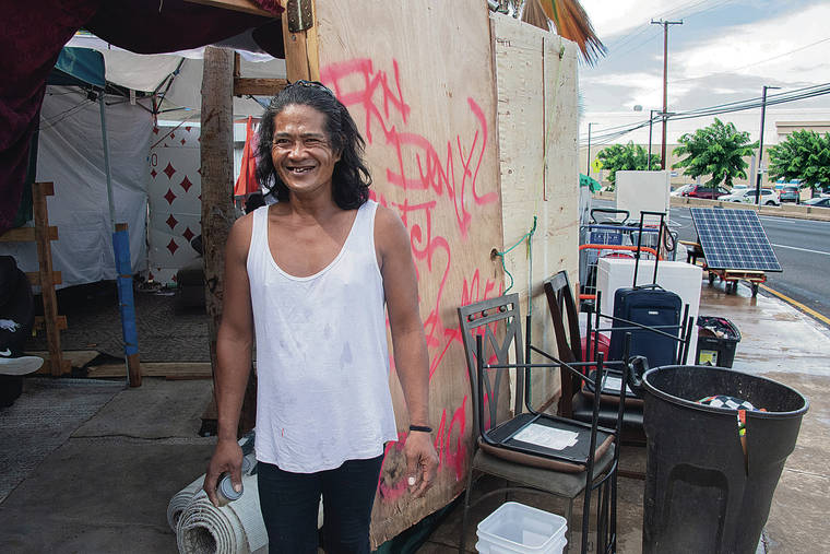 CRAIG T. KOJIMA / CKOJIMA@STARADVERTISER.COM
                                Francis Ladia did chores Monday at an encampment on Nimitz Highway. Ladia has been living on the streets for 20 years and in the Iwilei area for 10.