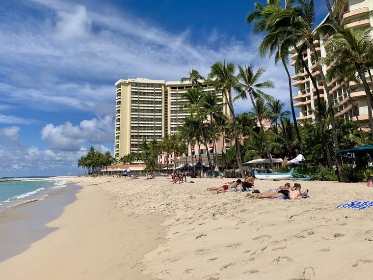 ERICK BENGEL / SPECIAL TO THE STAR-ADVERTISER
                                Beachgoers at Waikiki were few and spread out the day after the state opened for tourists pre-tested for COVID-19.
