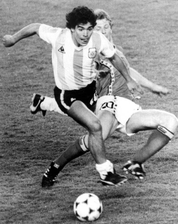 ASSOCIATED PRESS / JUNE 13, 1982
                                Argentina’s Diego Maradona, front, is attacked by Belgium’s Guy Vandermissen during the opening game of the Soccer World Cup in Barcelona, Spain, in 1982. Maradona died from a heart attack on today in Buenos Aires. He was 60.