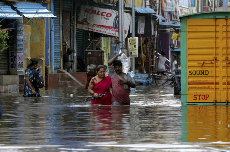 ASSOCIATED PRESS
                                People wade through a flooded street in Chennai, India, today. India’s southern state of Tamil Nadu is bracing for Cyclone Nivar that is expected to make landfall on Wednesday. The state authorities have issued an alert and asked people living in low-lying and flood-prone areas to move to safer places.