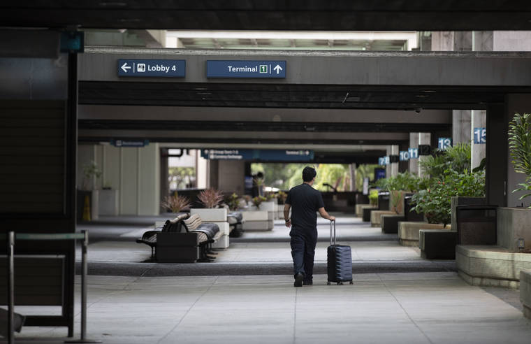CINDY ELLEN RUSSELL / NOV. 22
                                A man walks along the empty thoroughfare of Terminal 2 at Daniel K. Inouye International Airport on Sunday. Starting today, trans-Pacific travelers to Hawaii, who can’t present a negative pre-arrivals test upon arrival, won’t be able to bypass the 14-day quarantine once their test arrives.