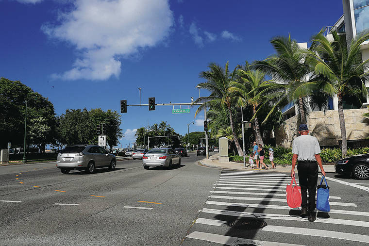JAMM AQUINO / JAQUINO@STARADVERTISER.COM
                                A pedestrian crossed Kamakee Street at Ala Moana Boulevard on Saturday in Kakaako. An elevated walkway over Ala Moana Boulevard is proposed for the area.