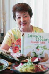 STAR-ADVERTISER / 2006
                                Muriel Kaminaka holds a first printing of her Japanese food cookbook. Some of her dishes are in front of her.