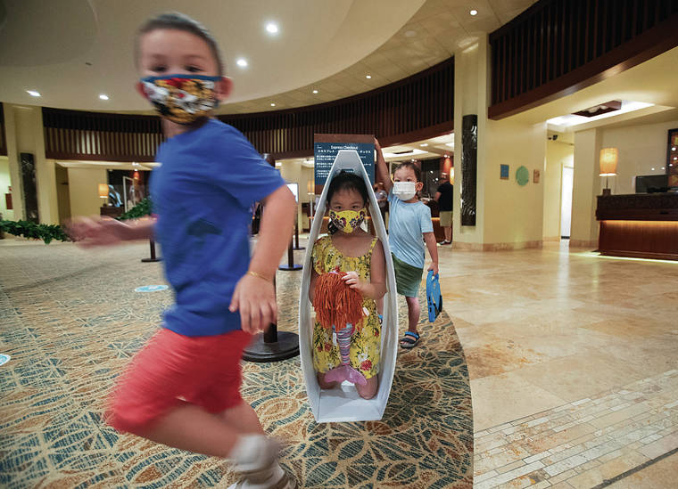 CINDY ELLEN RUSSELL / CRUSSELL@STARADVERTISER.COM
                                While waiting for their parents to check in, 5-year-old Caitlin Chanthavong-Phungma hid in a sign as 4-year-old Tristan Inthasone ran past in the hotel lobby. Also pictured to the right is Caitlin’s 3-year-old brother, Connor.