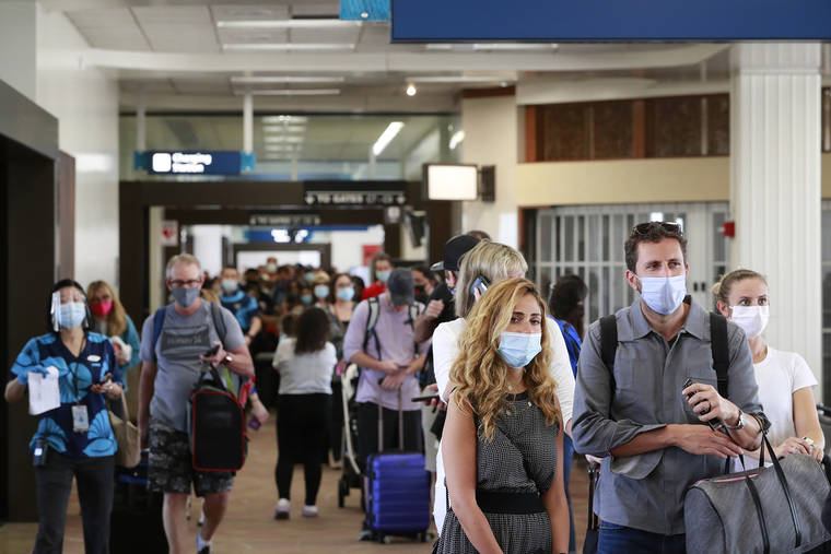 ASSOCIATED PRESS / OCTOBER 15
                                Visitors line a corridor in the Daniel K. Inouye International Airport as they enter the state.