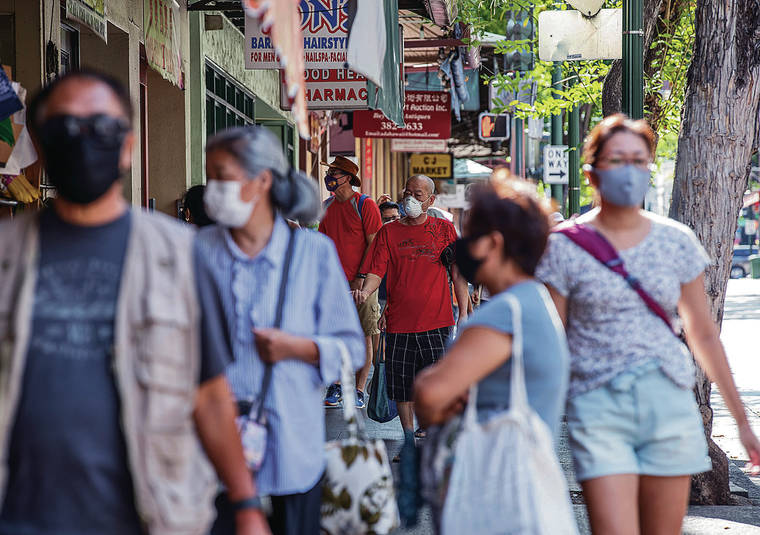 CINDY ELLEN RUSSELL / CRUSSELL@STARADVERTISER.COM
                                It was business as usual Monday as people walked along North Hotel Street in Chinatown with masks on.
