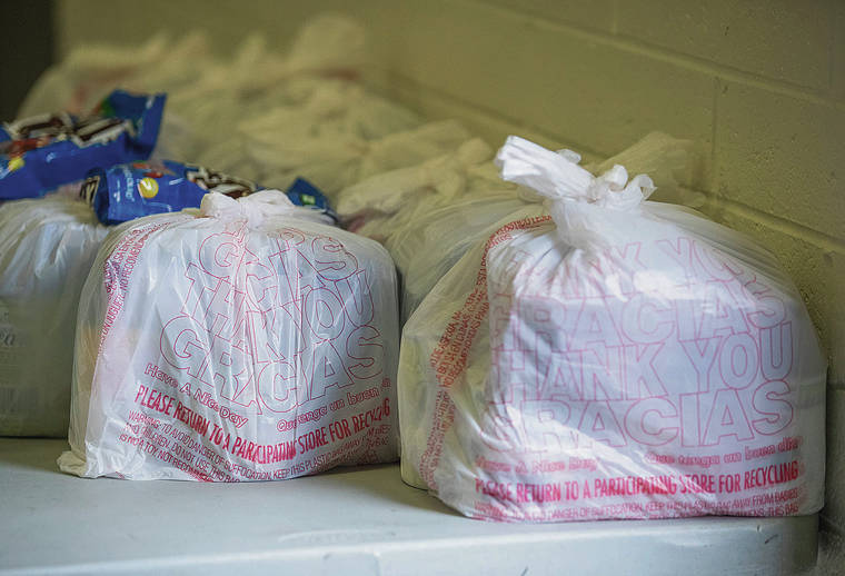 CINDY ELLEN RUSSELL / CRUSSELL@STARADVERTISER.COM
                                The Susannah Wesley Community Center in Kalihi is running out of food to distribute to the needy and is holding an emergency Thanksgiving donation drive-thru Saturday. Bags of groceries awaited pickup Thursday.