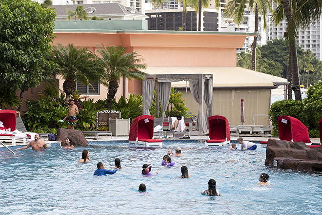 CINDY ELLEN RUSSELL / CRUSSELL@STARADVERTISER.COM
                                Guests enjoy the pool at the Sheraton Waikiki on Friday. Tourism in Hawaii has increased in the last weeks since the state began pre-travel testing, but is still well below year-ago levels.