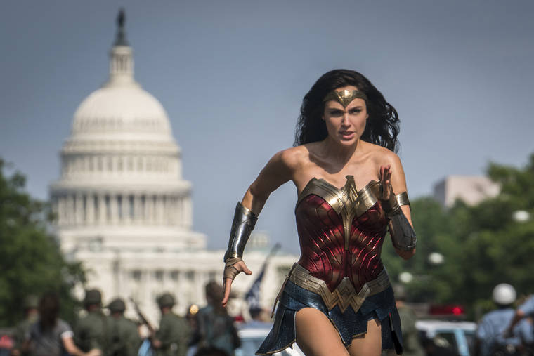 WARNER BROS. VIA AP
                                This image released by Warner Bros. Pictures shows Gal Gadot as Wonder Woman in a scene from “Wonder Woman 1984.” The last big blockbuster of 2020 is still opening in U.S. theaters on Christmas Day but it will also be made available to HBO Max subscribers free of charge for its first month, Warner Bros. said Wednesday.