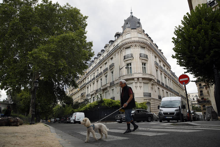 ASSOCIATED PRESS / 2019
                                A man walks his dog next to an apartment building owned by Jeffrey Epstein in Paris. Modeling agent Jean-Luc Brunel who was close to U.S. financier Jeffrey Epstein has been taken into custody in France, suspected of an array of crimes, including the rape of minors and trafficking minors for sexual exploitation, Paris prosecutors said Thursday. The prosecutors’ office said Jean-Luc Brunel was detained for questioning on Wednesday.