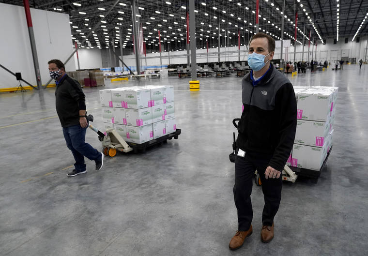 ASSOCIATED PRESS
                                Boxes containing the Moderna COVID-19 vaccine are moved to the loading dock for shipping at the McKesson distribution center in Olive Branch, Miss., Sunday, Dec. 20, 2020.