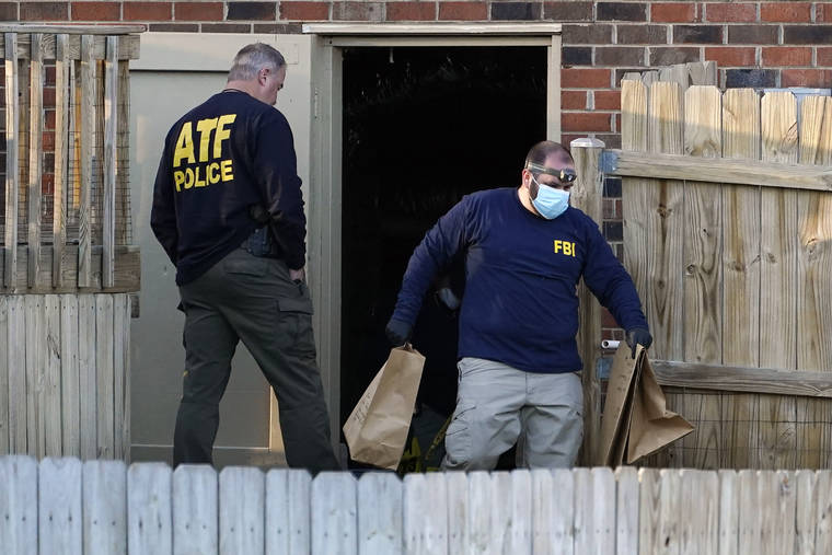 ASSOCIATED PRESS
                                Investigators remove items from the basement of a home Saturday in Nashville, Tenn. An explosion that shook the largely deserted streets of downtown Nashville early Christmas morning shattered windows, damaged buildings, and wounded three people.