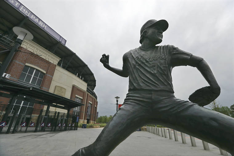 ASSOCIATED PRESS / MARCH 31
                                A statue of Atlanta Braves pitcher Phil Niekro stands outside Truist Park in Atlanta.