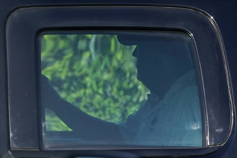 ASSOCIATED PRESS
                                President Donald Trump rides in a motorcade vehicle as he departs his Mar-a-Lago resort.