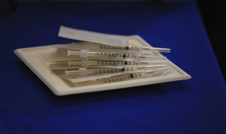 JAMM AQUINO / JAQUINO@STARADVERTISER.COM
                                Syringes of the Pfizer COVID-19 vaccine are seen on a table on Dec. 15 at the Queen’s Medical Center in Honolulu.