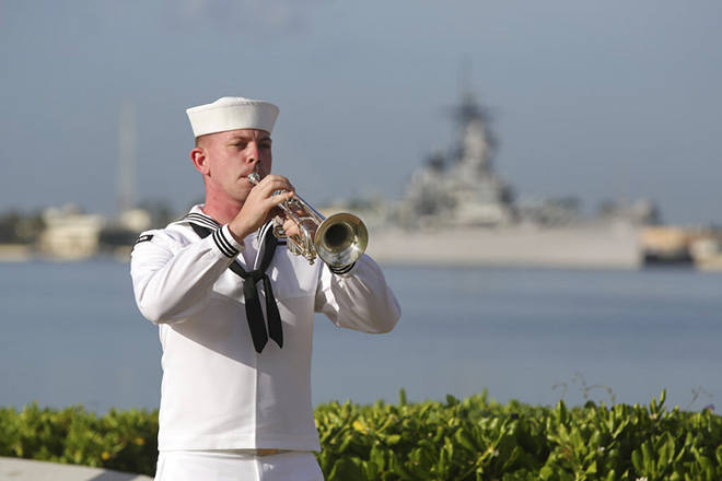 CALEB JONES / ASSOCIATED PRESS
                                A U.S. Navy sailor plays taps in front of the USS Missouri during a ceremony to mark the anniversary of the attack on Pearl Harbor, today. Officials gathered in Pearl Harbor to remember those killed in the 1941 Japanese attack, but public health measures adopted because of the coronavirus pandemic meant no survivors were present. A moment of silence was held at 7:55 a.m., the same time the attack began 79 years ago.