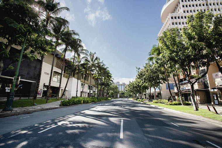 CINDY ELLEN RUSSELL / APRIL 6
                                No traffic, no tourists — the pandemic left a normally bustling Kalakaua Avenue in Waikiki barren of cars and pedestrians.