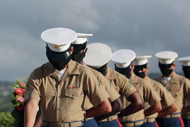 ASSOCIATED PRESS 
                                U.S. Marines wearing masks paused Monday during prayer at the ceremony marking the attack on Pearl Harbor, above. A moment of silence was held at 7:55 a.m., the same time the attack began 79 years ago.