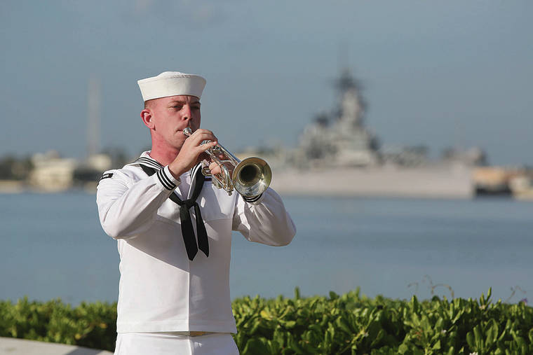 ASSOCIATED PRESS 
                                 A Navy sailor, played taps in front of the USS Missouri during the ceremony.