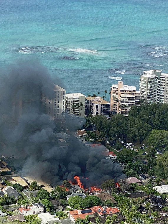 COURTESY SWAPNAL ACHARYA / JAN. 19
                                Smoke filled the sky as homes burned on Hibiscus Drive near Diamond Head during a police shootout with a troubled resident that left two police officers dead in January.