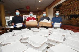 CINDY ELLEN RUSSELL / CRUSSELL@STARADVERTISER.COM
                                Victor Tan and his family coordinated with Mini Garden Chinese restaurant to get 100 Christmas meals to homeless youth. The meals were delivered to the Youth Outreach in Waikiki.